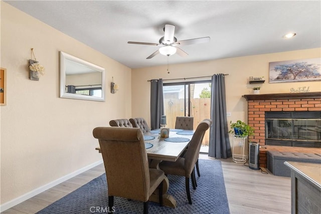 9375 Musselman Dr Unit A, Atascadero, CA 93422 - dining space with baseboards, ceiling fan, a fireplace, and light wood-type flooring