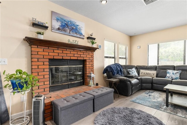 9375 Musselman Dr Unit A, Atascadero, CA 93422 - living room with visible vents, a brick fireplace, and wood finished floors