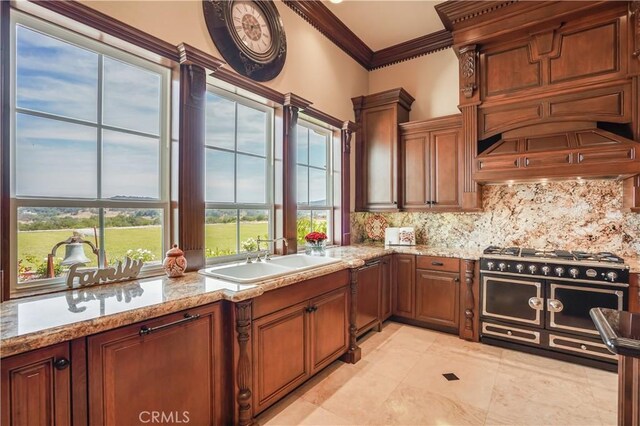 kitchen featuring ornamental molding, range with two ovens, a sink, dishwasher, and tasteful backsplash