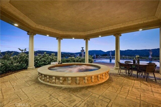 patio terrace at dusk with an in ground hot tub