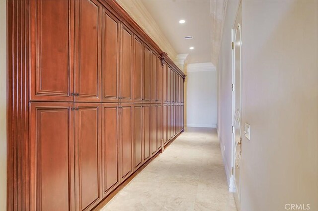 hallway featuring baseboards, ornamental molding, and recessed lighting