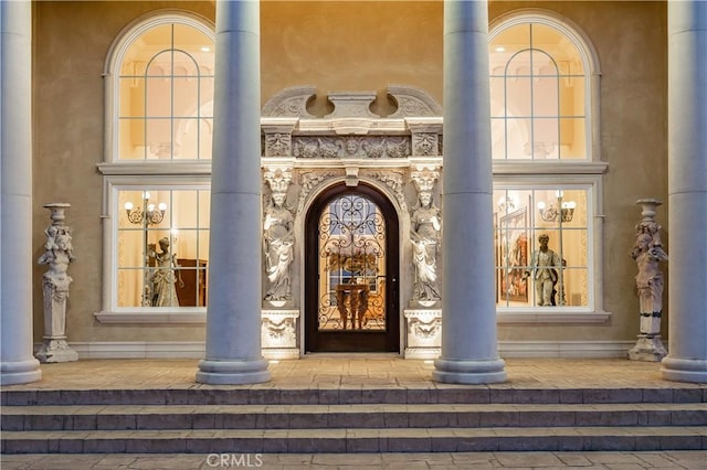 view of exterior entry featuring covered porch