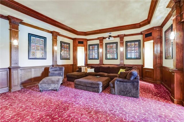 home theater room with carpet flooring, decorative columns, and ornamental molding