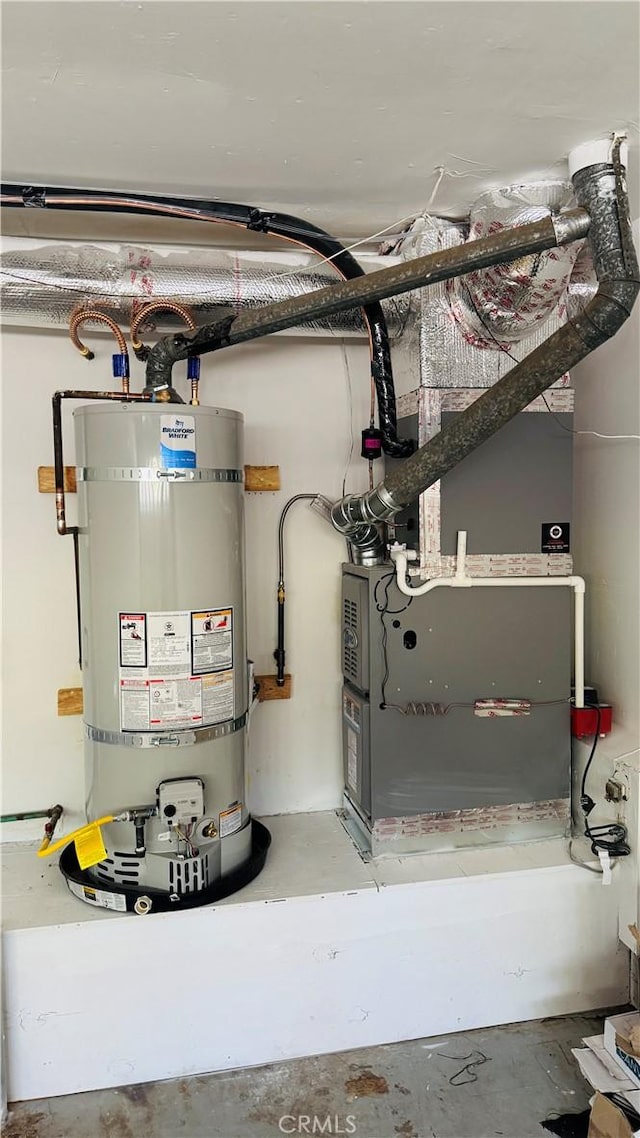 utilities featuring heating unit and strapped water heater