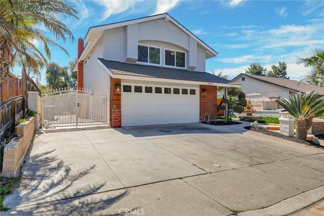 traditional home with fence, an attached garage, stucco siding, a gate, and driveway