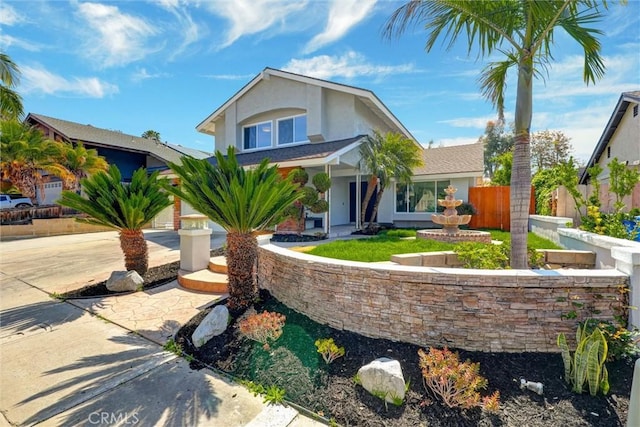 traditional-style home with stucco siding and fence