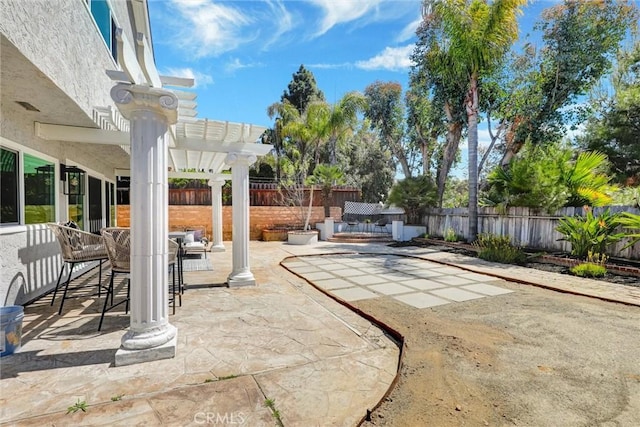 view of patio / terrace featuring a fenced backyard, a pergola, and outdoor dining space