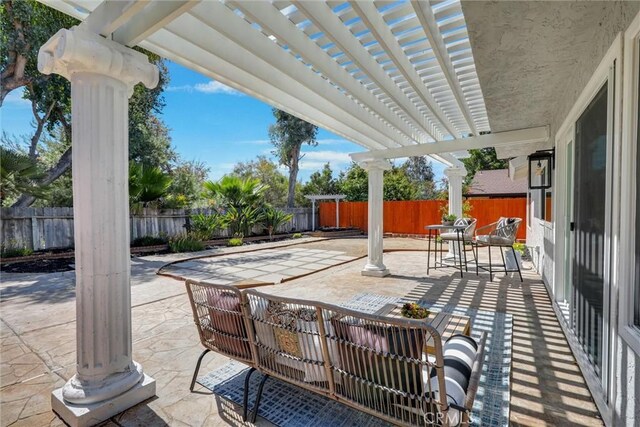 view of patio featuring an outdoor living space, a fenced backyard, and a pergola