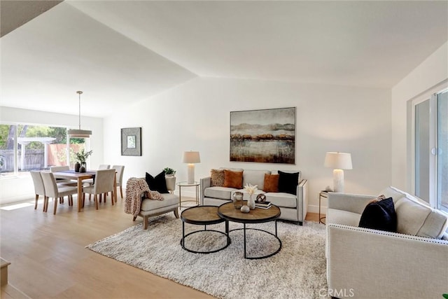 living room with light wood-type flooring and lofted ceiling