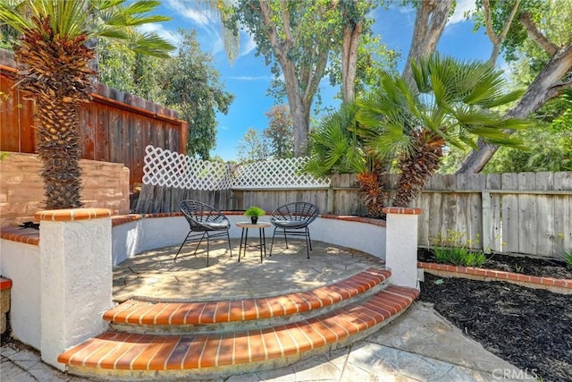 view of patio featuring a fenced backyard and outdoor dining space