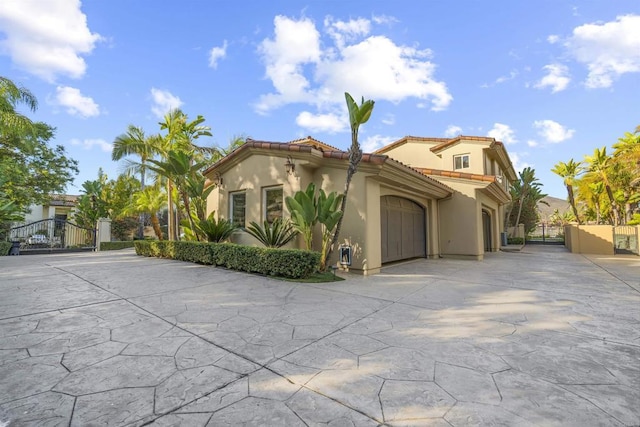2890 Gate Fifteen Pl, Chula Vista, CA 91914 - mediterranean / spanish house with a gate, stucco siding, driveway, and fence