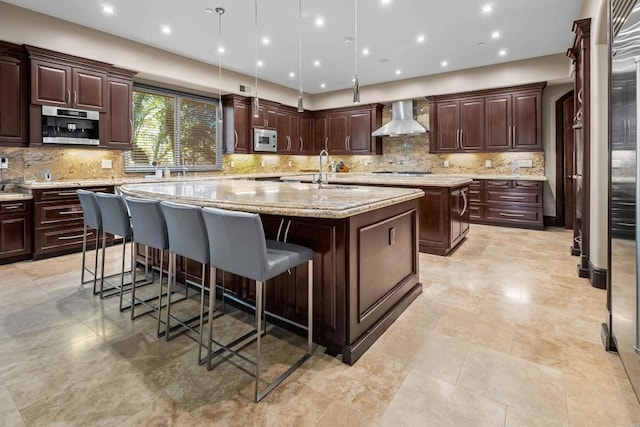 2890 Gate Fifteen Pl, Chula Vista, CA 91914 - kitchen featuring a center island with sink, wall chimney range hood, a sink, stainless steel appliances, and a kitchen breakfast bar