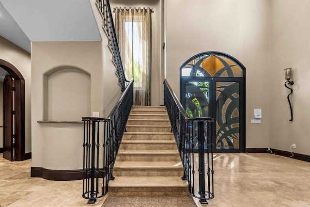 2890 Gate Fifteen Pl, Chula Vista, CA 91914 - entrance foyer featuring arched walkways, baseboards, and stairway