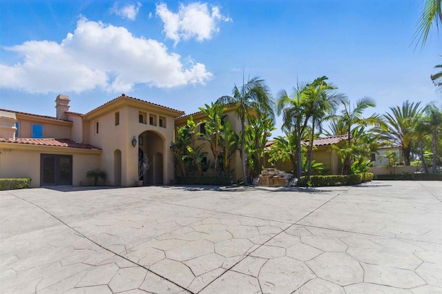 2890 Gate Fifteen Pl, Chula Vista, CA 91914 - mediterranean / spanish-style home featuring stucco siding, a chimney, and a tiled roof