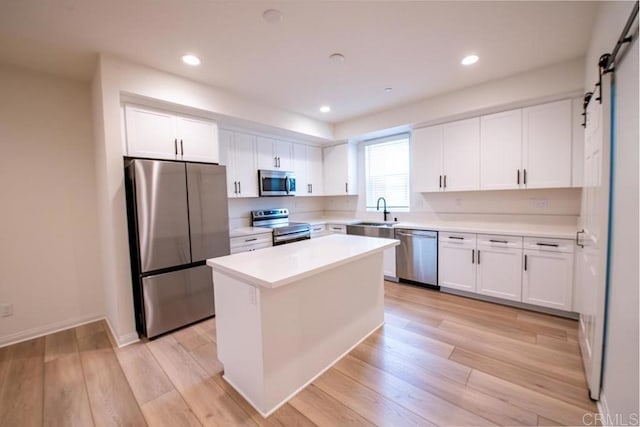 3507 Sequoia St, Lemon Grove, CA 91945 - kitchen featuring appliances with stainless steel finishes, a sink, light countertops, white cabinetry, and a kitchen island