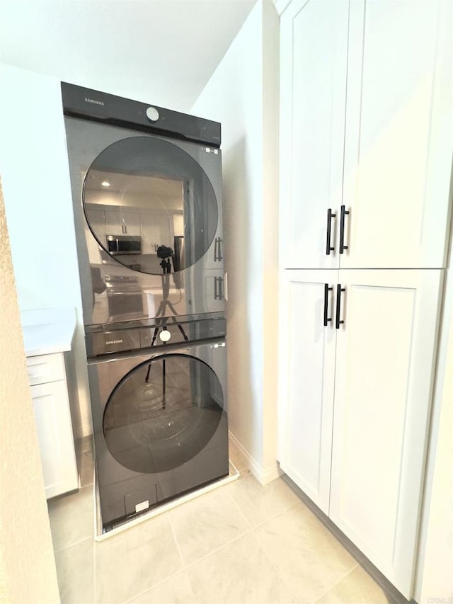 3507 Sequoia St, Lemon Grove, CA 91945 - laundry room with baseboards, stacked washer / drying machine, light tile patterned flooring, and cabinet space