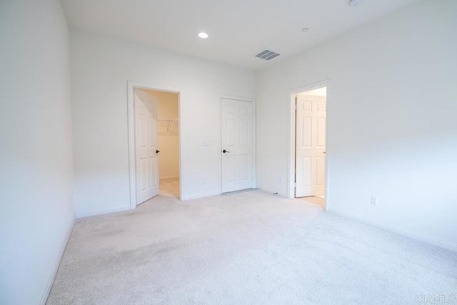 3507 Sequoia St, Lemon Grove, CA 91945 - unfurnished bedroom featuring light colored carpet, a walk in closet, recessed lighting, baseboards, and visible vents