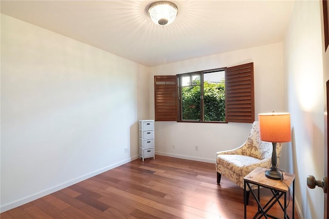 living area with baseboards and hardwood / wood-style floors