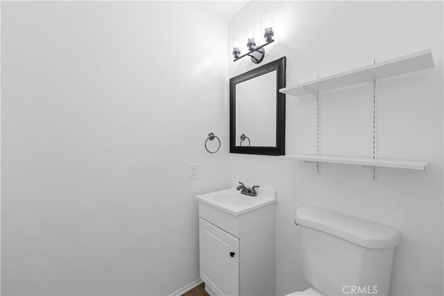 half bathroom with toilet and vanity