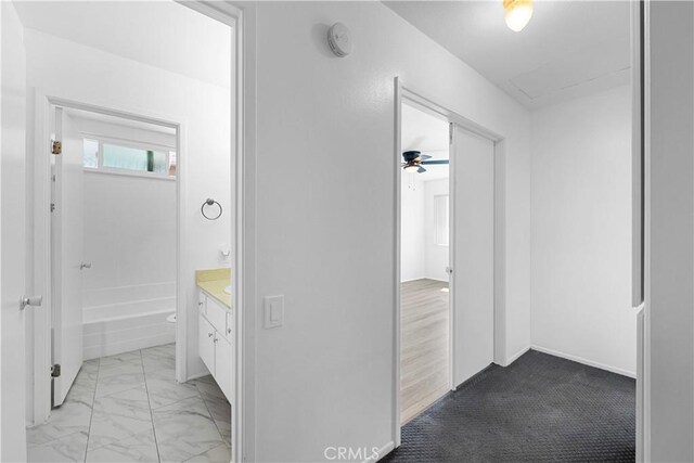 hallway with marble finish floor