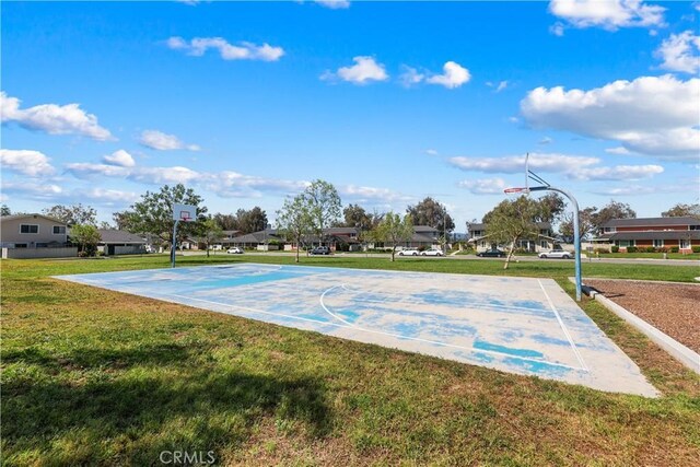 view of sport court with a yard, community basketball court, and a residential view