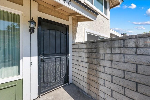doorway to property with stucco siding