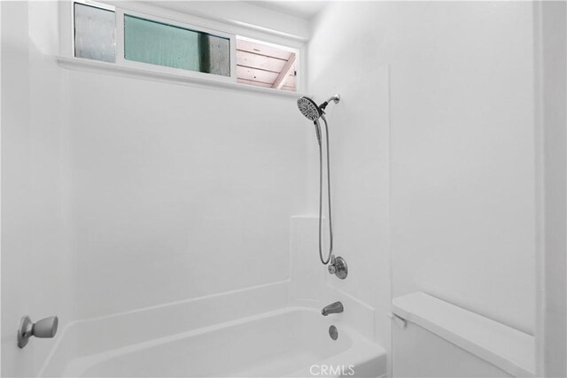 bathroom featuring toilet and tub / shower combination