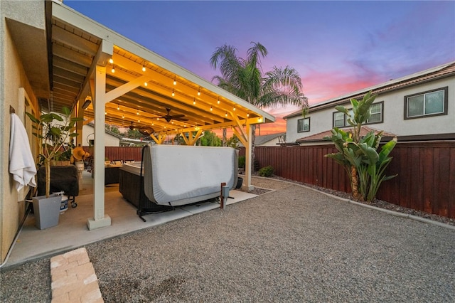 1123 Ticonderoga Ln, Hemet, CA 92545 - patio terrace at dusk featuring a fenced backyard, a patio, and a ceiling fan