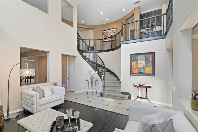 13744 Star Ruby Ave, Eastvale, CA 92880 - living room featuring visible vents, stairs, wood finished floors, baseboards, and recessed lighting
