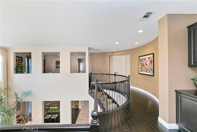 13744 Star Ruby Ave, Eastvale, CA 92880 - hallway featuring visible vents, baseboards, recessed lighting, dark wood finished floors, and an upstairs landing