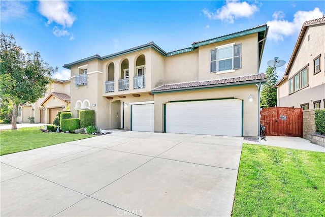 13744 Star Ruby Ave, Eastvale, CA 92880 - mediterranean / spanish home with an attached garage, stucco siding, driveway, and a tile roof