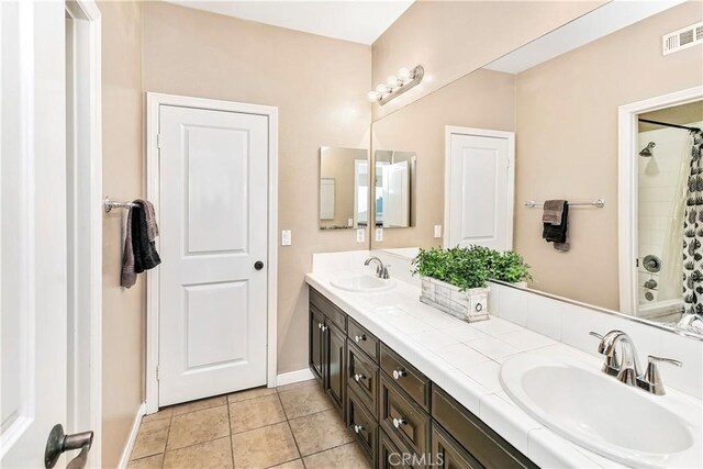 13744 Star Ruby Ave, Eastvale, CA 92880 - bathroom with a sink, baseboards, tile patterned flooring, and visible vents