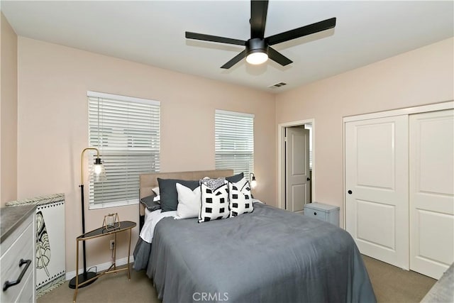 13744 Star Ruby Ave, Eastvale, CA 92880 - bedroom featuring light colored carpet, a ceiling fan, visible vents, and a closet