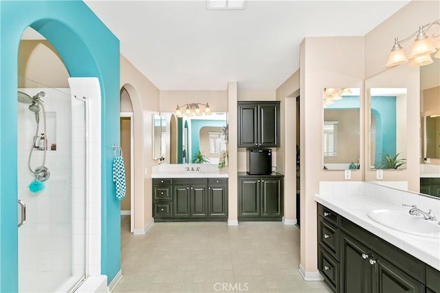 13744 Star Ruby Ave, Eastvale, CA 92880 - bathroom featuring baseboards, a sink, and a shower stall