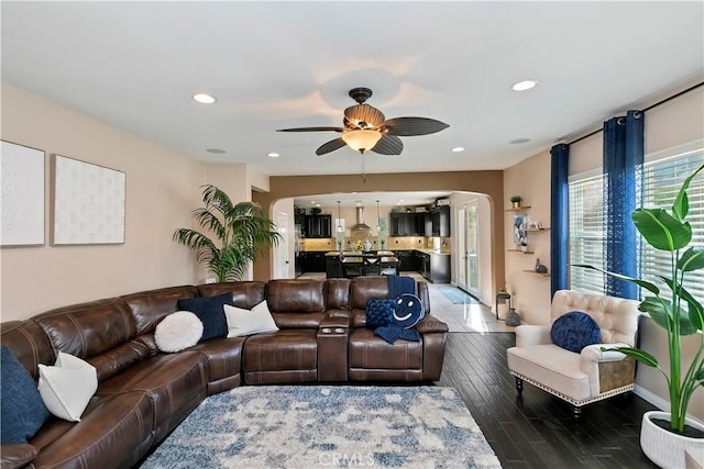 13744 Star Ruby Ave, Eastvale, CA 92880 - living area featuring recessed lighting, arched walkways, a ceiling fan, and dark wood-style floors