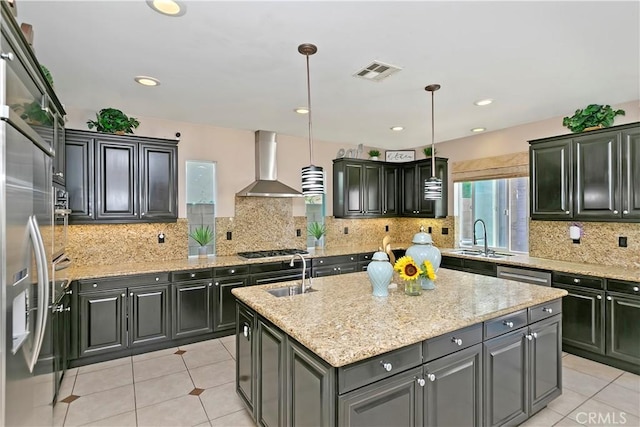 13744 Star Ruby Ave, Eastvale, CA 92880 - kitchen with wall chimney range hood, a center island with sink, a sink, and visible vents