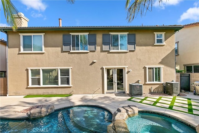 13744 Star Ruby Ave, Eastvale, CA 92880 - rear view of property with a patio area, stucco siding, french doors, and cooling unit