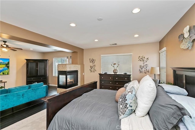 13744 Star Ruby Ave, Eastvale, CA 92880 - bedroom with a multi sided fireplace, multiple windows, and recessed lighting