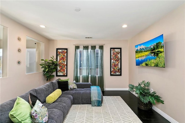 13744 Star Ruby Ave, Eastvale, CA 92880 - living area featuring baseboards, visible vents, recessed lighting, and dark wood-type flooring