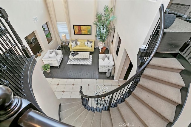 13744 Star Ruby Ave, Eastvale, CA 92880 - staircase with a high ceiling, visible vents, and tile patterned floors