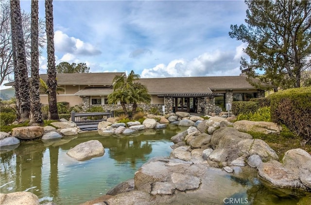 exterior space featuring a garden pond