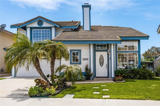 view of front of house featuring concrete driveway, a front yard, a chimney, and a garage