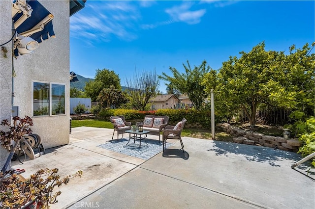 view of patio with outdoor lounge area and fence