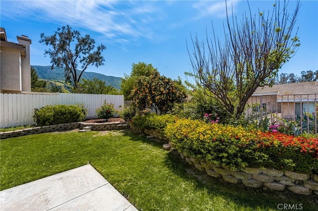 view of yard with a mountain view and fence