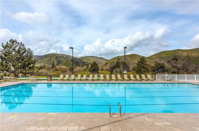 pool featuring fence and a mountain view