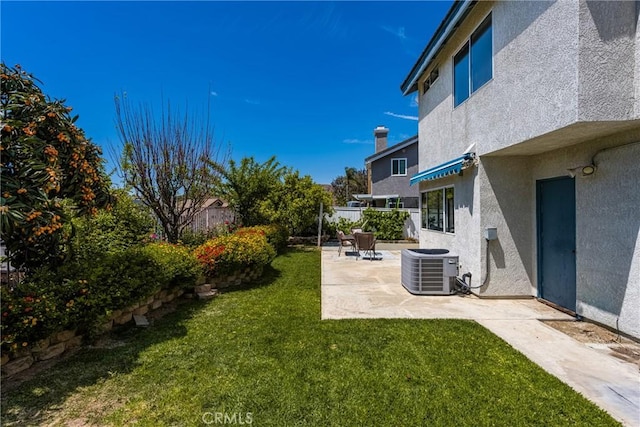 view of yard featuring central AC unit, a patio area, and fence