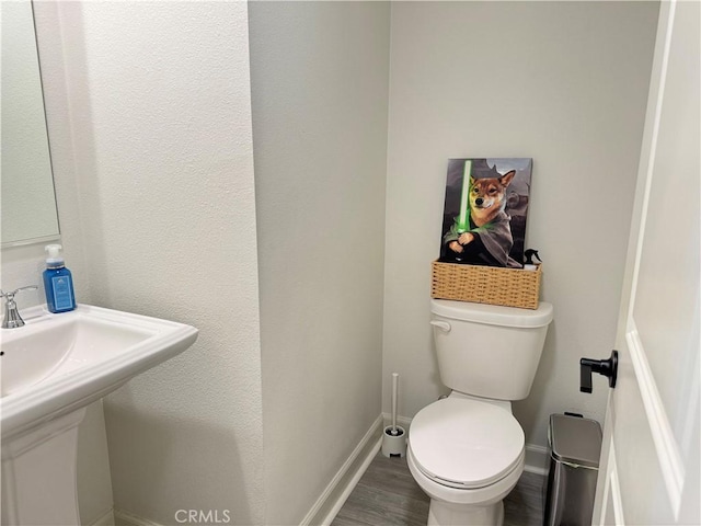 3530 E Delight Paseo Unit 205, Ontario, CA 91761 - bathroom with toilet, baseboards, wood finished floors, and a sink