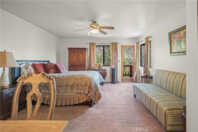 carpeted bedroom featuring ceiling fan and access to exterior
