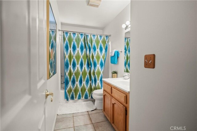 bathroom with vanity, shower / bathtub combination with curtain, tile patterned floors, and toilet