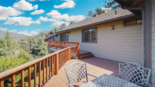 wooden deck with a mountain view
